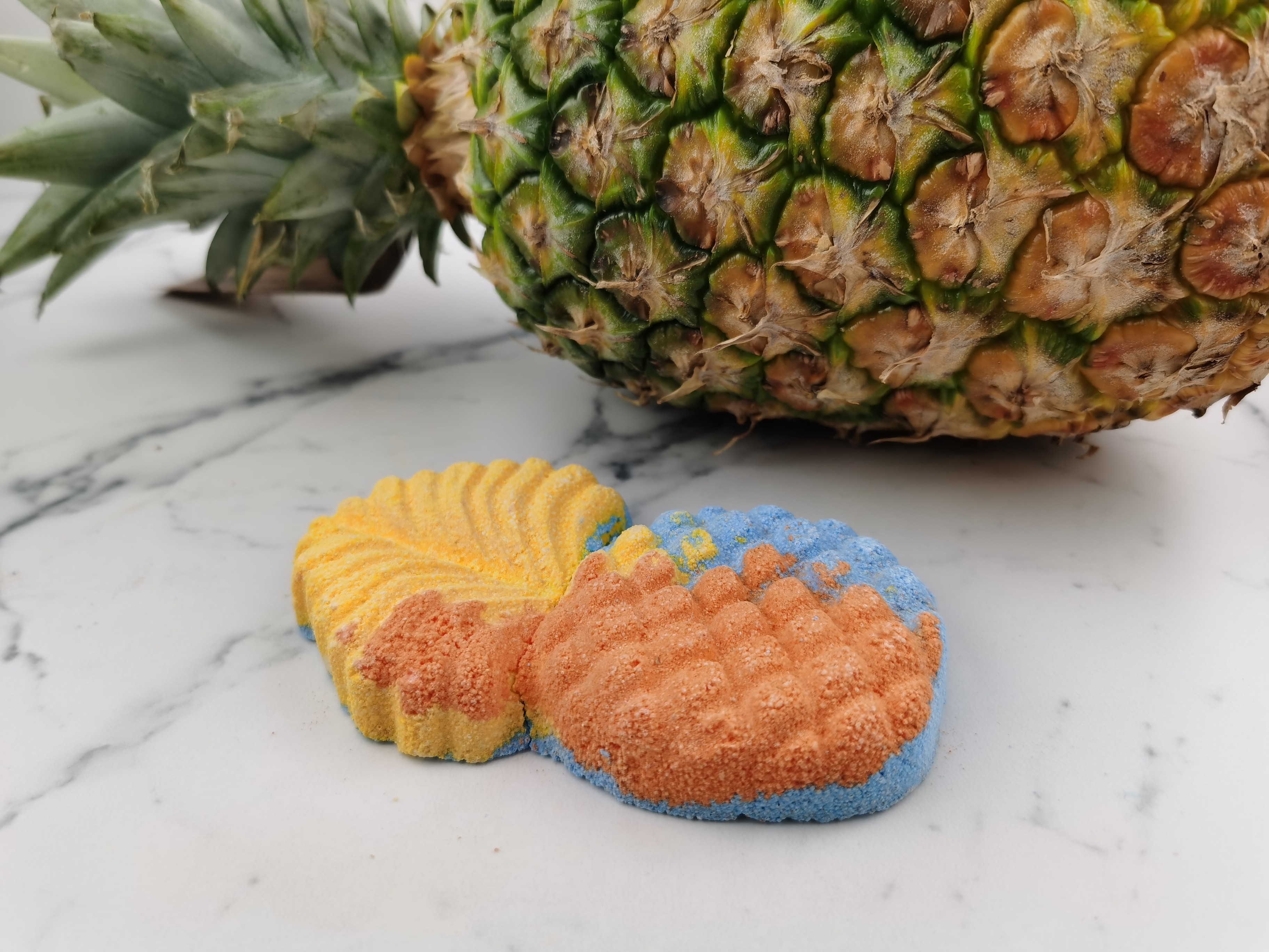 Island Juice Bath Bomb by Truth Niagara next to a real pineapple