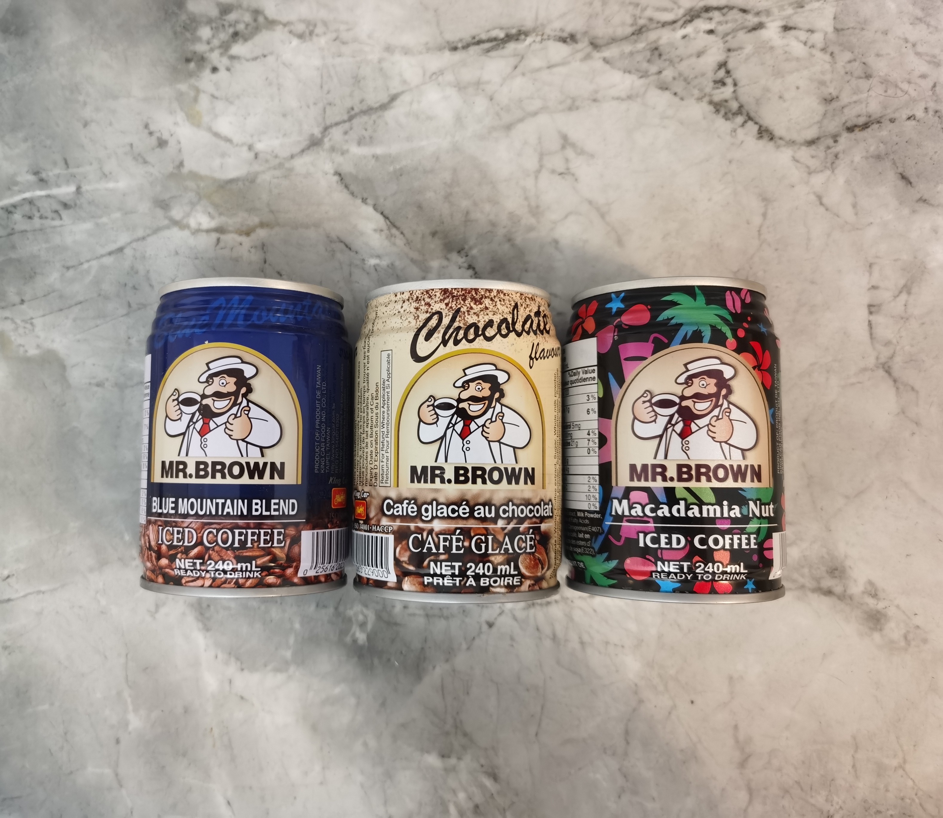 Mr. Brown Iced Coffee Cans on a marble background