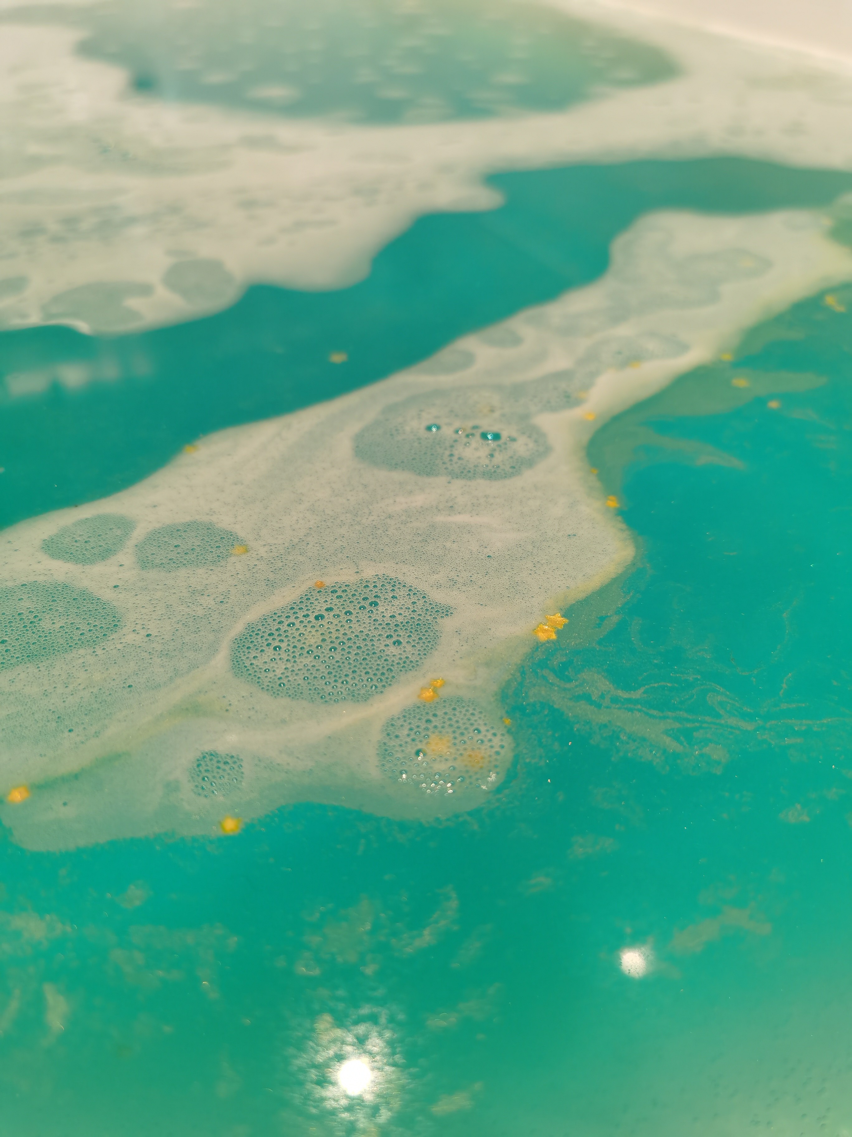 little golden stars in water from the Golden Wonder Bath Bomb by Lush