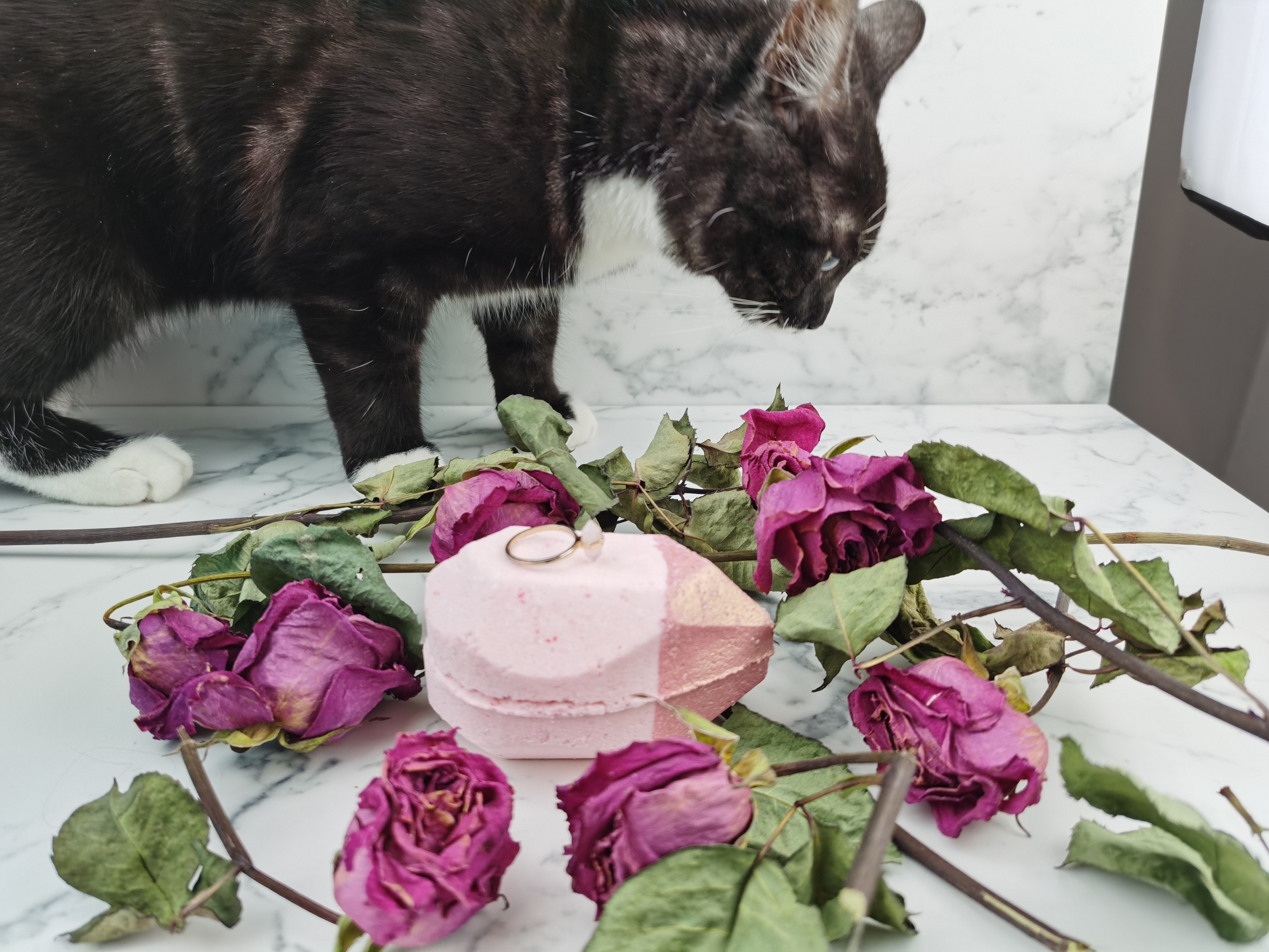 Rose Gold Shimmer Bath Bomb by Pearl Bath Bombs with flowers and cat on a marble background