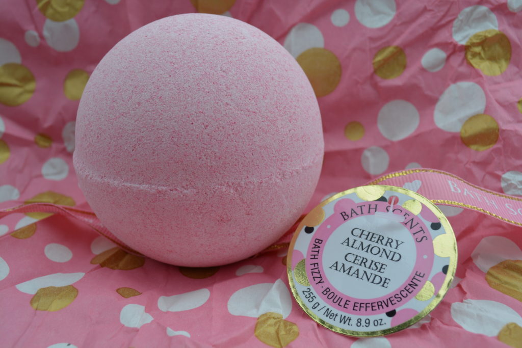 Cherry Almond Bath Bomb by Bath Scents (Dollarama) on a pink paper with white and golden dots
