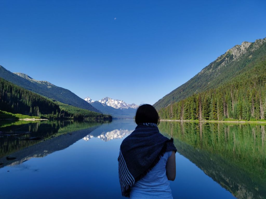 Woman staring out at lake and mountains