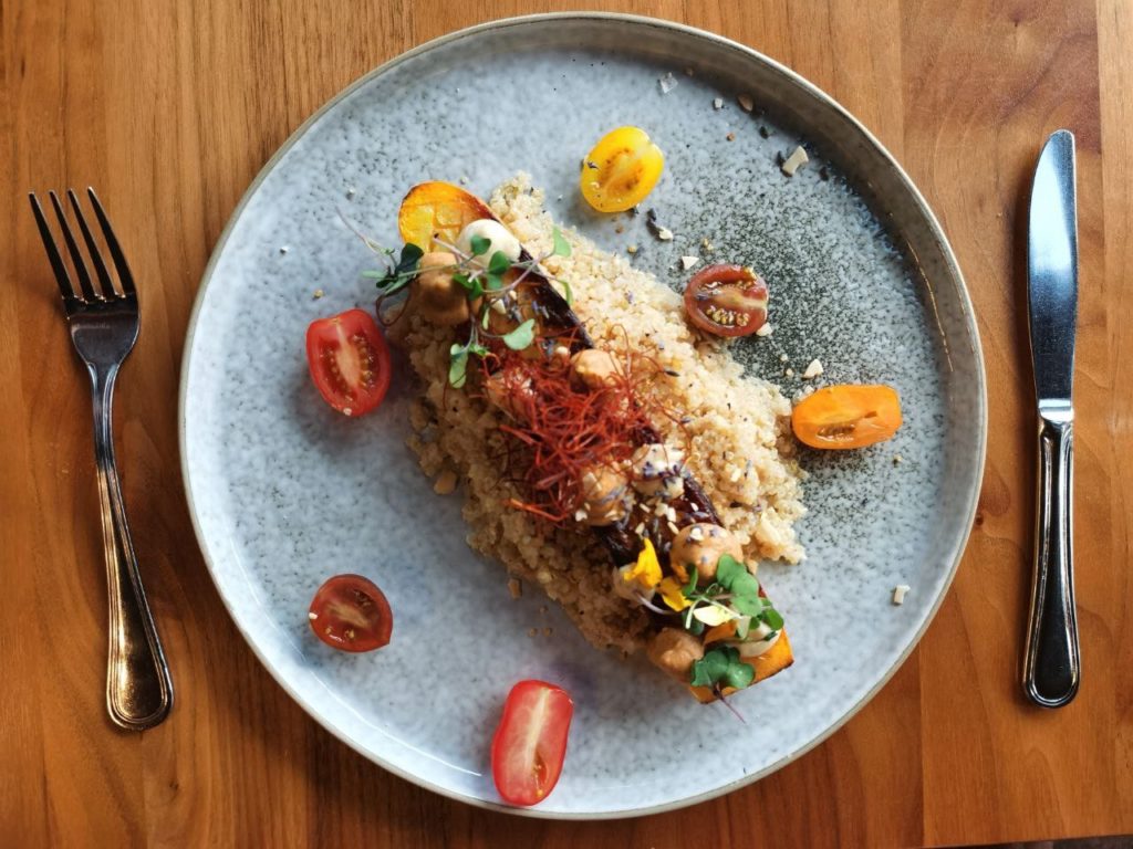 Zucchini meal from the pines restaurant plate on a wooden table