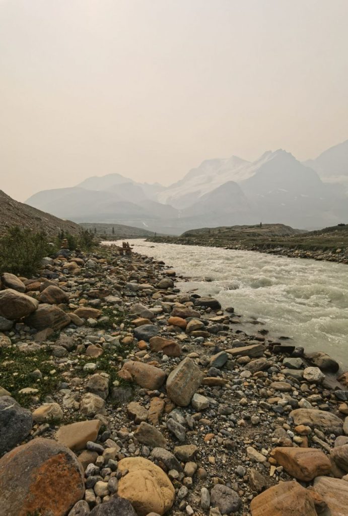 Canadian Rockies by a river with mountains in the background