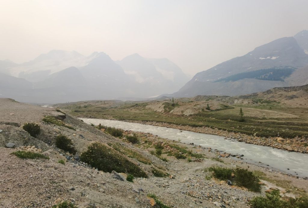 Canadian Rockies by a river with mountains in the background