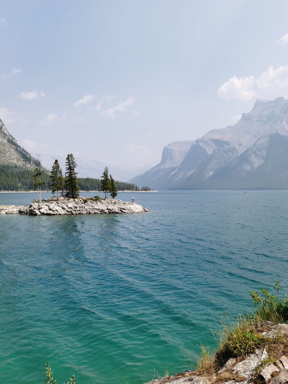 Lake Minnewanka mountain and trees in the lake vertical picture