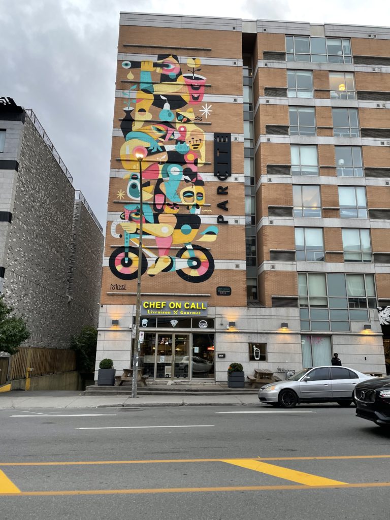 Colourful art piece on a building on top of a restaurant