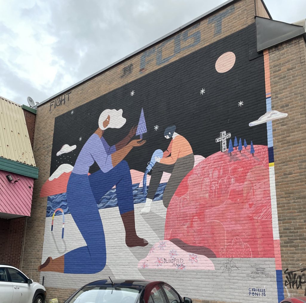 Art piece on a wall depicting two women in Montreal