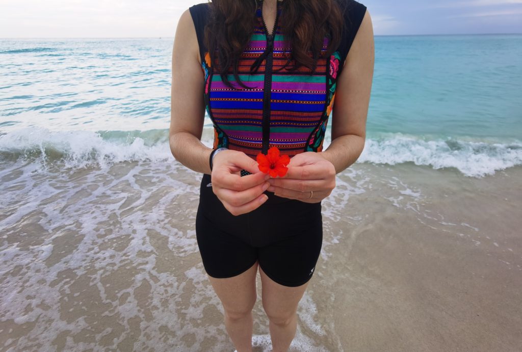 Girl holding a red flower on the beach in Varadero Cuba
