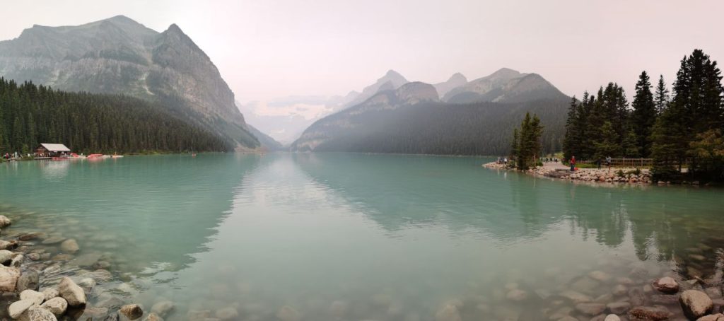 Lake Louise's turquoise Waterfront in Banff with mountains in the distance